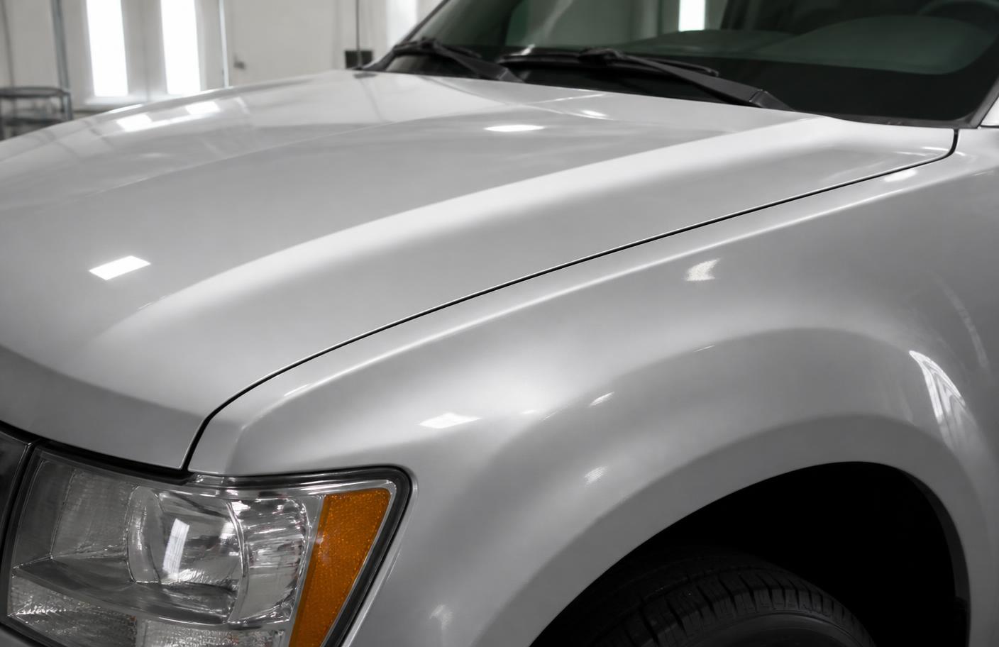 Truck hood and fender after paintless dent repair, smooth factory paint